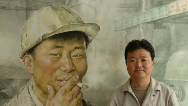 North Korean artist Im Hyok with his work "Break Time" at the Mansudae Art Studio in Pyongyang.