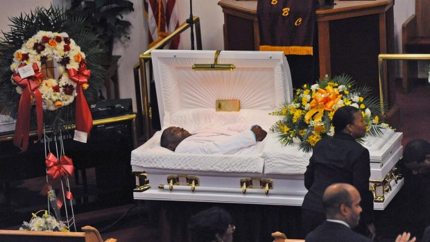 FILE - In this July 23, 2014, file photo, Eric Garner's body lies in a casket during his funeral at Bethel Baptist Church in the Brooklyn borough of New York. Garner, a 43-year-old man who was selling cigarettes on the street in Staten Island, died after an officer put him in a chokehold. Video of the incident shows no medical assistance was provided for at least six minutes. (Julia Xanthos/New York Daily News, Pool, via AP, File)