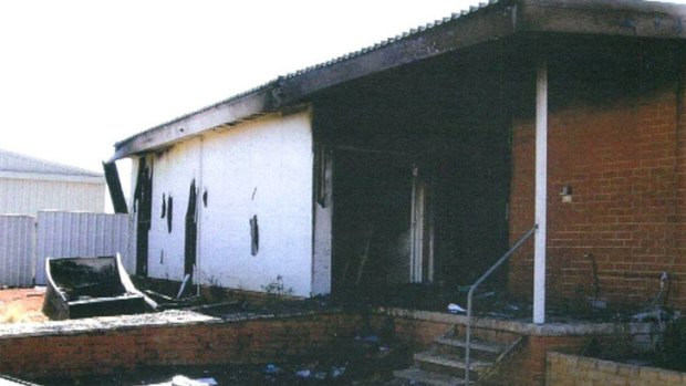 A former principal has been cleared of setting fire to his own school.
