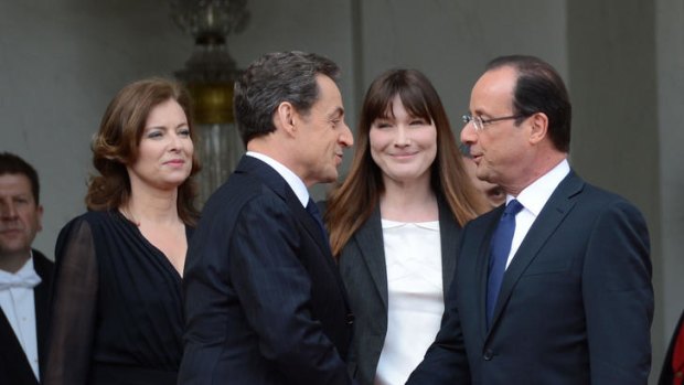 France's outgoing president Nicolas Sarkozy, left, shakes hands with the new resident of the Elysee Palace, Francois Hollande.