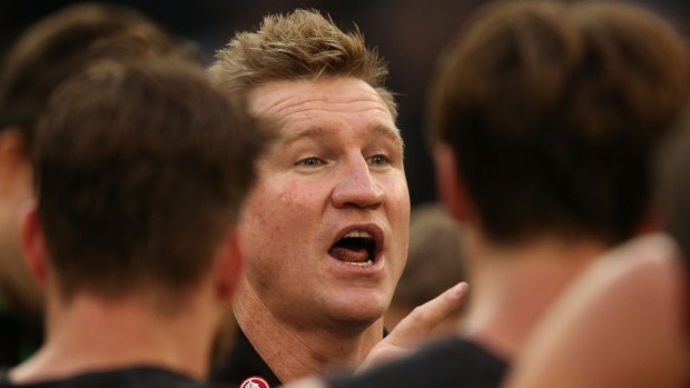 Magpies coach Nathan Buckley speaks to his players during a break in the game.