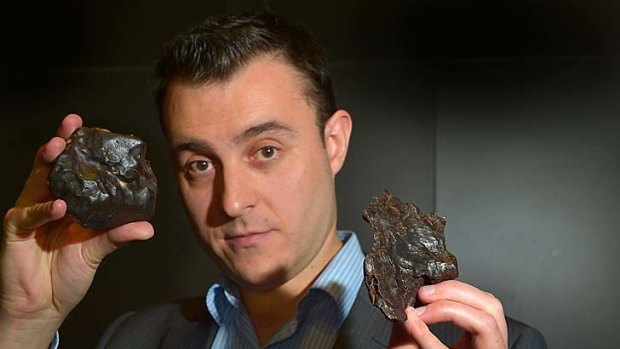 Down to earth &#8230; Jeff Kuyken holds a stone meteorite.