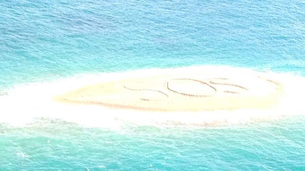 The giant SOS which the group carved into a sandbar.