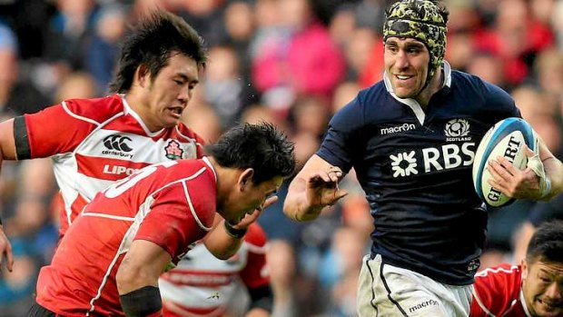 Rested: Scotland's captain Kelly Brown makes a break against Japan.