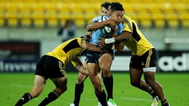 Bulldogs target: Waratah Israel Folau is tackled by the Hurricanes at Westpac Stadium.