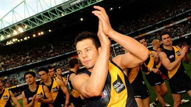 Richmond's Ben Cousins ends his AFL career with a lap of honour at Etihad Stadium yesterday.
