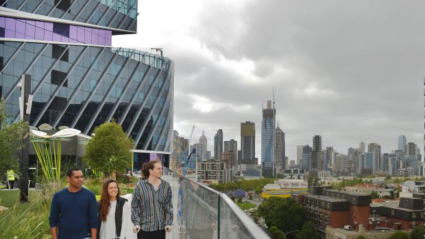 Theo Javangwe, Xenia Alexander and Liam Fergus enjoy the view from the rooftop garden at the Victorian Comprehensive Cancer Centre