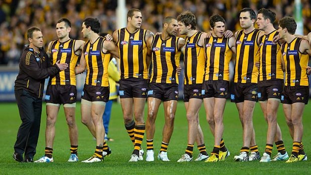 Alastair Clarkson and the Hawks during the national anthem before Friday's preliminary final.