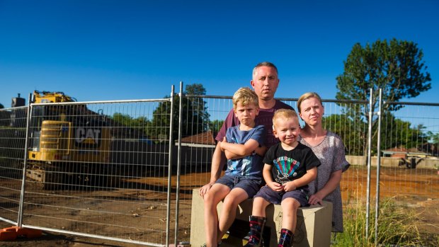 Anthony Steve, and Clare Steve with their kids Alexander Steve (7) and Oliver Steve (3) paid $1.6 million for a Mr Fluffy block however asbestos has been found on the land. Photo: Dion Georgopoulos