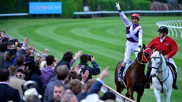 Standing ovation ... Glen Boss salutes the crowd after steering New Zealand star Ocean Park to a thrilling victory in the Cox Plate at Moonee Valley yesterday.