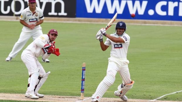 Promising start ... Usman Khawaja plays a confident shot against the Queensland attack but later missed a full toss to be dismissed leg before wicket.