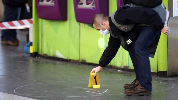 A police officer works at the site where a man attacked a soldier patrolling a subway station in Paris.