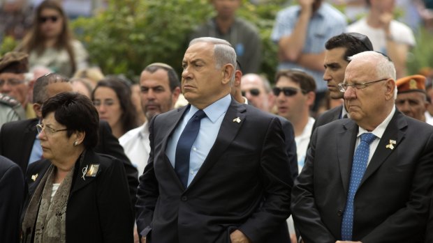 Israeli Prime Minister Benjamin Netanyahu (centre) stands with Israeli President Reuven Rivlin (right) during an official state Memorial Day service for the country's fallen soldiers and victims of terrorism.