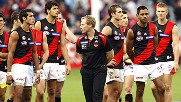 Essendon coach Matthew Knights with his players after Sunday's loss to Collingwood.