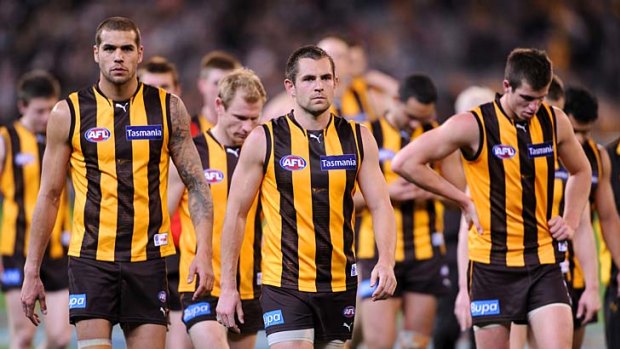 A dejected Luke Hodge leads the Hawthorn players off the ground.