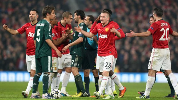 Manchester United players react after Nani was shown a red card.