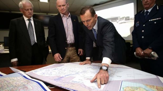 Opposition Leader Tony Abbott, Queensland Premier Campbell Newman and Liberal MP Philip Ruddock survey the Torres Strait on a map during their visit to the Queensland Police Command Centre in Brisbane.