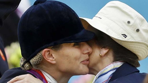 A kiss from mum ... Britain's Zara Phillips, left, is congratulated by her mother Princess Anne, as she receives her medal from her.