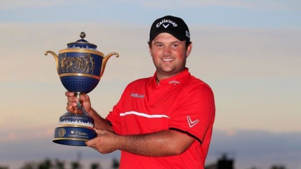 Patrick Reed celebrates with the Gene Sarazen Cup after his one-stroke victory.
