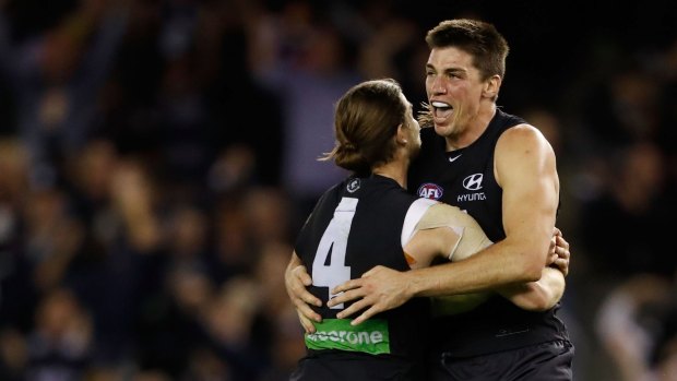 MELBOURNE, AUSTRALIA - MAY 15: Matthew Kreuzer of the Blues (right) celebrates the match winning goal with Bryce Gibbs of the Blues during the 2016 AFL Round 08 match between the Carlton Blues and Port Adelaide Power at Etihad Stadium, Melbourne on May 15, 2016. (Photo by Adam Trafford/AFL Media/Getty Images)