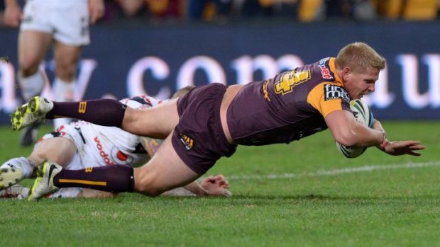 Big Ben: Broncos front-rower Ben Hannant dives over for a rare four-pointer against the Warriors.