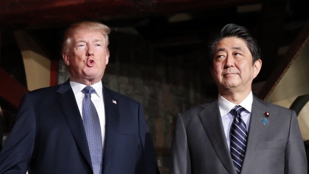 President Donald Trump, left, and Japanese PM Shinzo Abe. Mr Trump has spoken about the latest mass shooting in America.