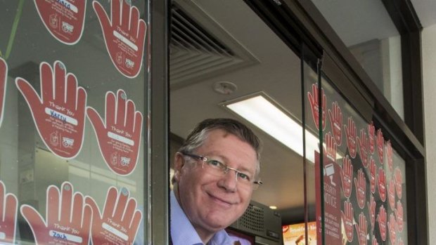 All in a day's work: Premier Dennis Napthine offers service with a smile at McDonald's in Wendouree. 
