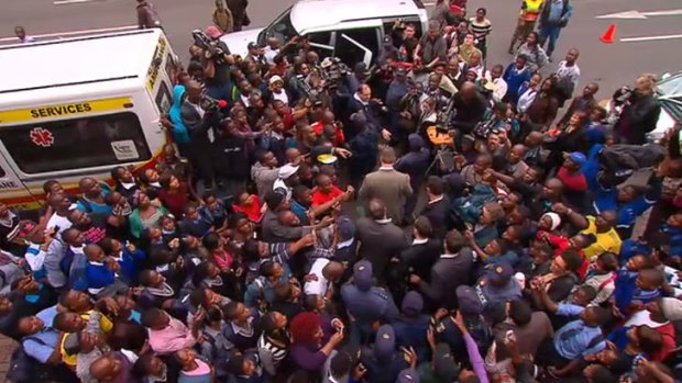 Crowds swarm Oscar Pistorius as he leaves court.