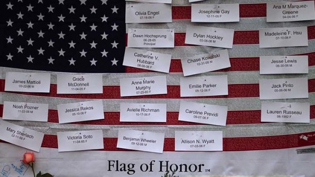 Victims of the Newtown school shooting are remembered on a U.S. flag. A further 4000 Americans have been killed by gun since this massacre.