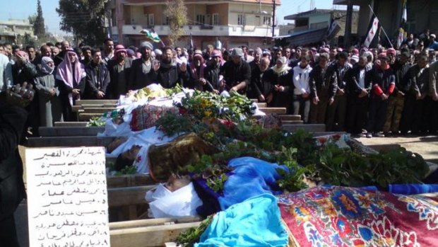Syrians attend a mass funeral for people whom anti-government protesters said were killed by the shelling in Al Qasseer city, near Homs, last week.