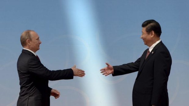 Russian President Vladimir Putin and Chinese President Xi Jinping shake on their gas agreement.