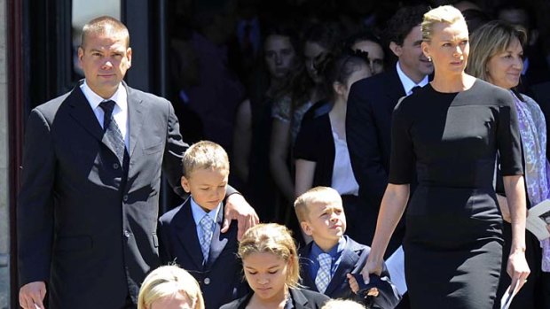 Visible ... Lachlan and Sarah Murdoch with their children Kalan and Aidan at the service.