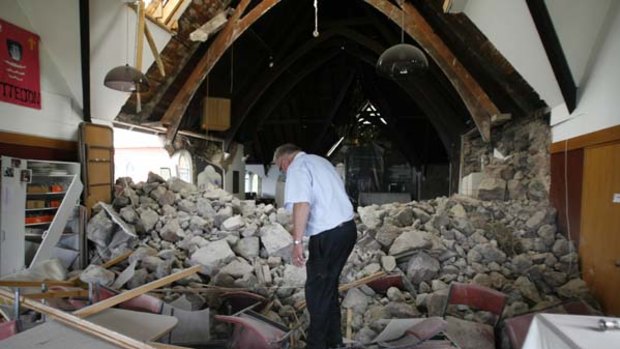 Ruined ... Neil Struthers inspects Holy Trinity Church.