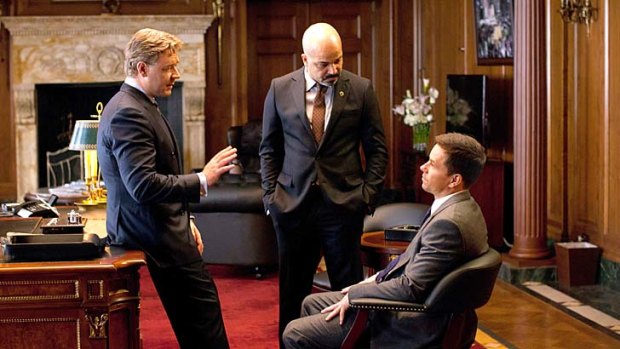 Russell Crowe (left) and Mark Wahlberg (seated) in Broken City.