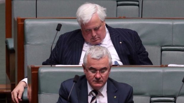 Clive Palmer rests his eyelids during question time, sitting behind fellow crossbench MP Andrew Wilkie.
