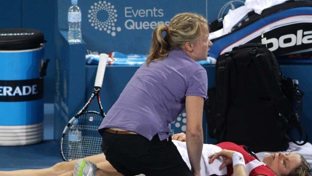 Sore ... Kim Clijsters withdraws from her semi-final match against Daniela Hantuchova on Friday night.