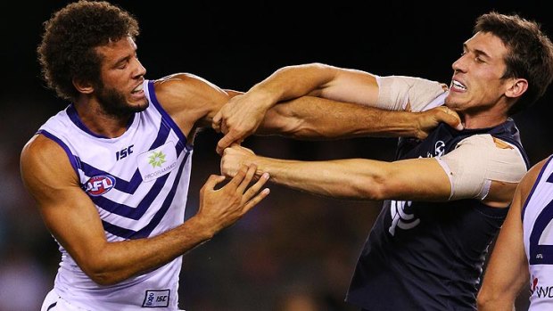 Zac Clarke (left) limped out of Fremantle training on Tuesday morning and is in doubt for Saturday's season-opener.