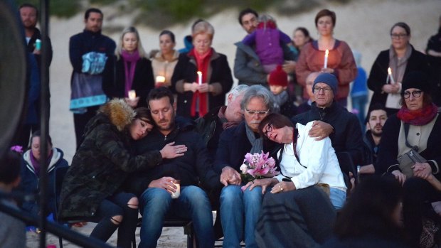 Justine's parents Maryan Heffernan, and John Ruszczyk, right, with their son Jason Ruszczyk and his wife Katarina Ruszczyk, left at Freshwater Beach during a vigil for their daughter following her shooting death.