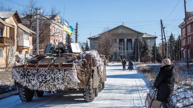 Ukrainian forces pass through the centre of Myronivskyi, Ukraine. A ceasefire has failed to prevent fighting in the nearby town of Debaltseve, where thousands of Ukrainian troops remain and whom rebels claim to have surrounded. 