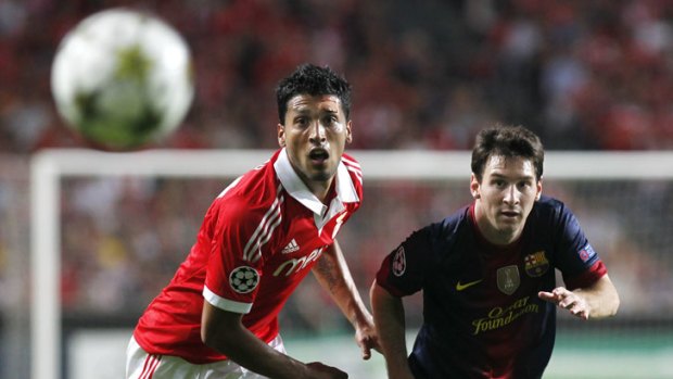 Barcelona's Lionel Messi (right) and Benfica's Ezequiel Garay eye the ball during their Champions League match in Lisbon.