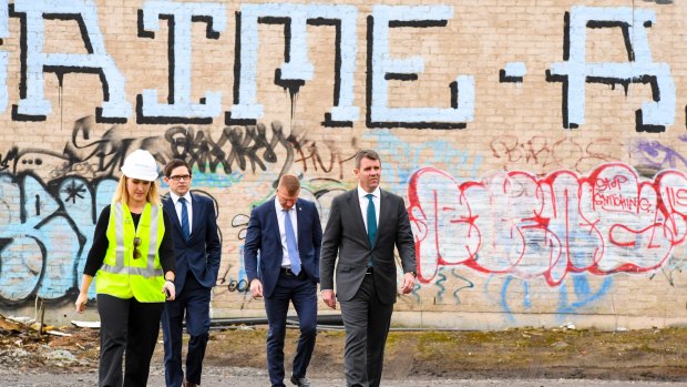 NSW Premier Mike Baird (right) arrives at the goods yard in Rozelle on Thursday to announce the extension.