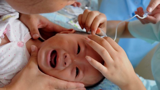 A Chinese toddler undergoes treatment at a hospital after taking tainted milk powder.