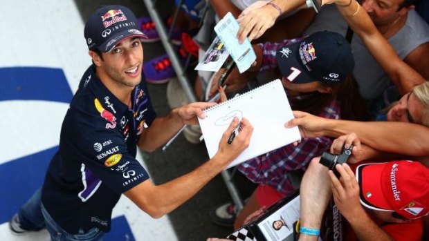 Daniel Ricciardo signs autographs ahead of a possible third-straight formula one championship win in Monza. 