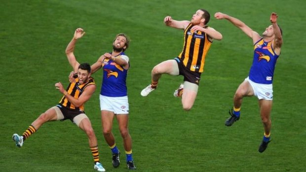Jarryd Roughead (second from right) flies for a mark.