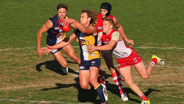 Caught: Sydney's Dan Hannebery tackles West Coast's Matt Priddis.