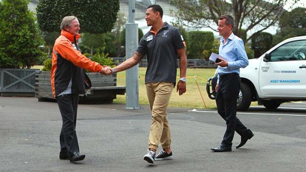 Farewell friend ... Israel Folau is greeted by GWS coach Kevin Sheedy before announcing his retirement.