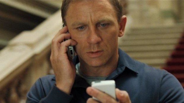 Daniel Craig holding two phones in <i>Casino Royale</i>.