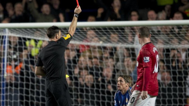 Shock ... Chelsea's Fernando Torres is shown the red card by referee Mark Clattenburg.