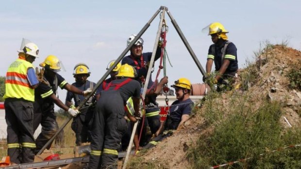 Rescue workers used hoists to move away debris in a bid to get to the trapped men.