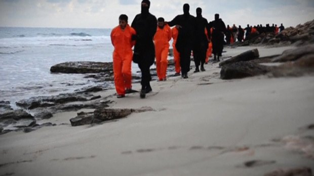 Twenty-one Egyptian Christians in orange jumpsuits appear in an Islamic State video being marched by IS militants along a beach, said to be near Tripoli, before each captive is beheaded.